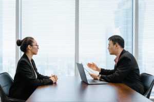 Woman and man meeting at conference table.
