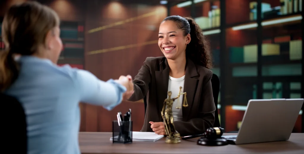 Female Lawyer And Hispanic Client Shake Hands